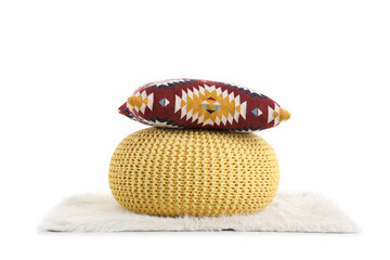 Comfortable soft pouf with pillow on rug on white background
