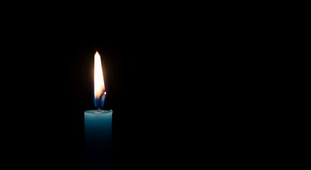 Burning Teal Candle Against Black Background - Symbol of Awareness and Silent Prayer
