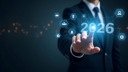 Obraz premium Happy New Year 2026: Businessman Touching Virtual Screen to Set New Goals and Strategies for Future Growth - Planning Opportunities for 2026 and Beyond