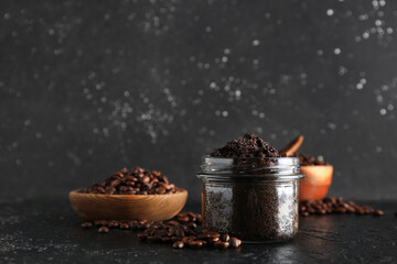 Jar with coffee body scrub on black grunge background