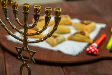 Sweet triangular gomentashi ears of aman for the holiday of Purim on the table