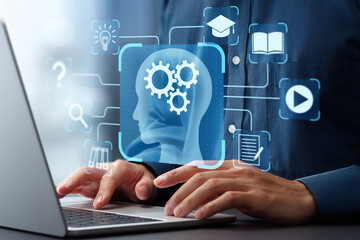 E-learning and online education systems. Online training programs and personalized learning. Man using laptop computer to learn with digital educational content.