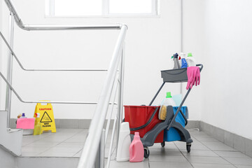 Trolley with cleaning supplies in stairway