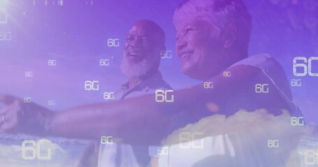 Elderly couple on beach using 6G technology with animated overlay - Powered by Adobe