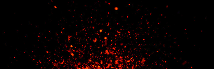 Glowing ember particles drift and flicker against a dark background, creating warm, intense energy...