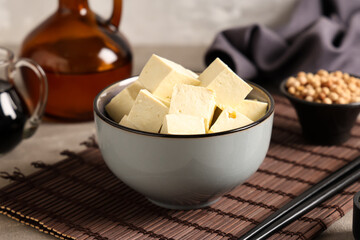 Bowl of tasty tofu cheese on table