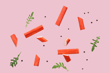 Tasty crab sticks with peppercorns and arugula leaves flying on pink background © Pixel-Shot