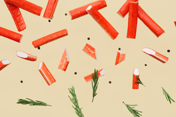 Tasty crab sticks with rosemary and peppercorns flying on green background © Pixel-Shot