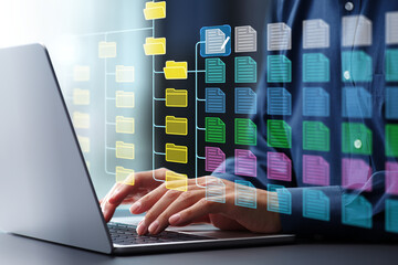 Document management system DMS and version control.Folder structure and classification system. File and folder icons. Businessman using laptop computer.