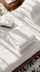 Neatly Folded White Towels on Hotel Bed, Minimalist Comfort and Cleanliness
