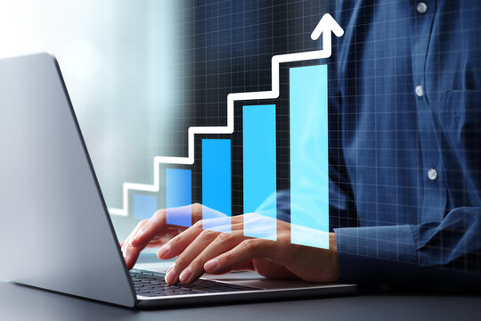 Growth graph and step up arrow. Business growth strategy and technological solutions. Businessman using laptop computer to manage business operations.