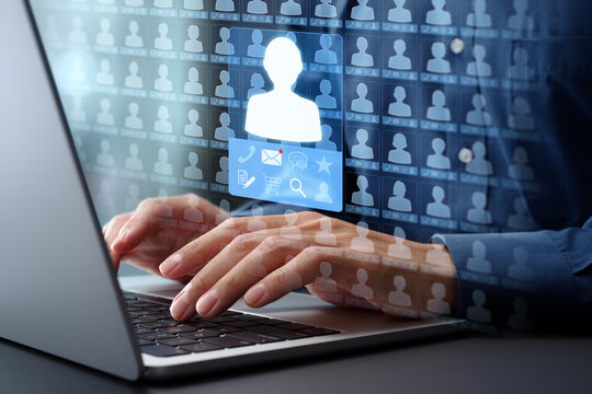 Customer relationship management CRM and database of information. Client data collection system and accessing list. Businessman typing on laptop computer keyboard at desk in office.