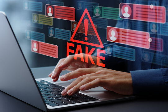 Fake news on social media. Social media manipulation and disinformation. Man using laptop computer to post on social media.