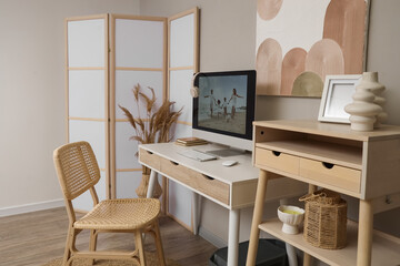 Interior of office with photographer's workplace and folding screen