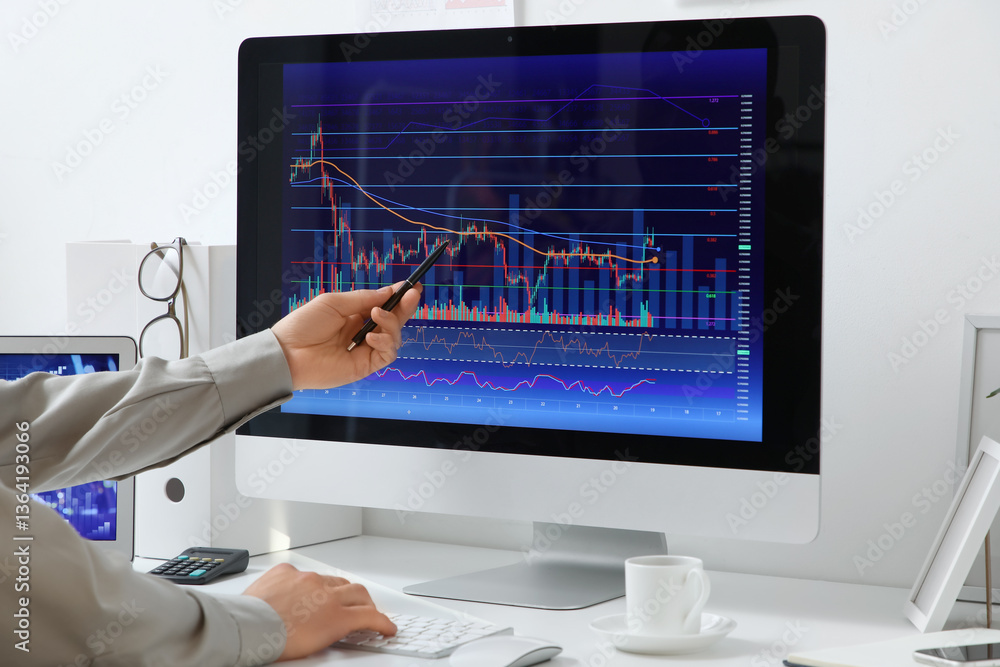 Poster male trader working with computer at table in office, closeup