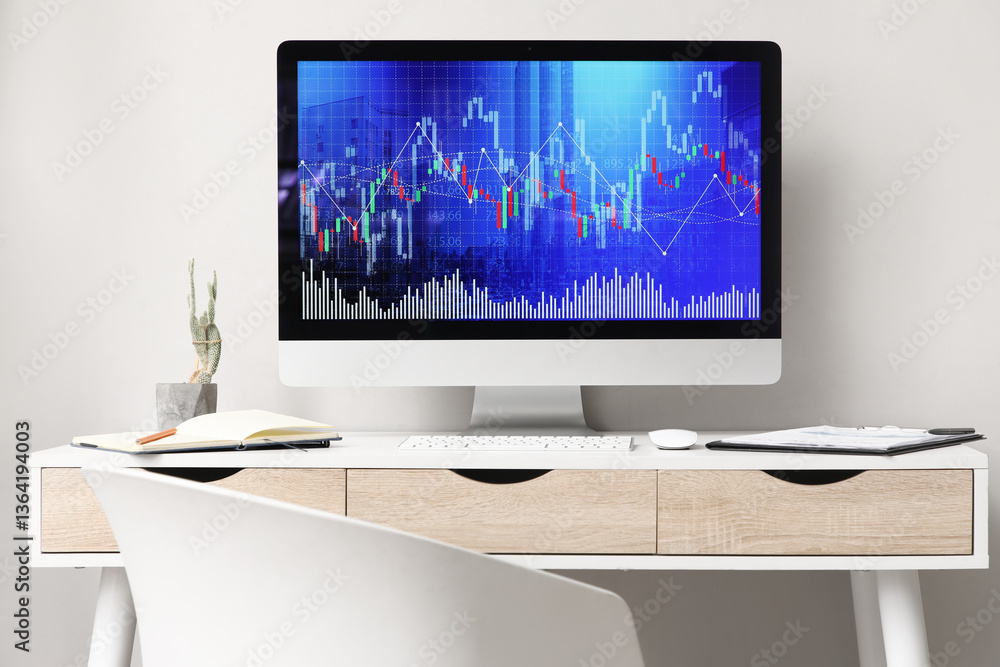 Aufkleber computer monitor with diagrams of exchange rates on table in trader's office