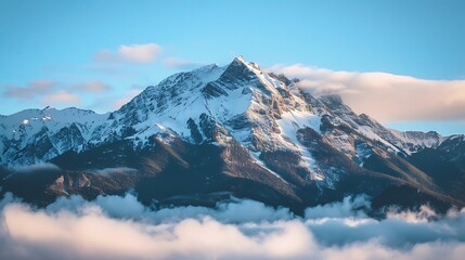 A majestic mountain peak covered in snow, standing tall above the clouds