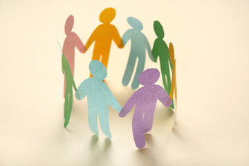 Paper human figures on light background. Inclusion concept