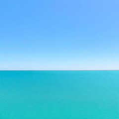 Obraz premium Calm turquoise sea under a clear blue sky; perfect for travel brochures or relaxation themes