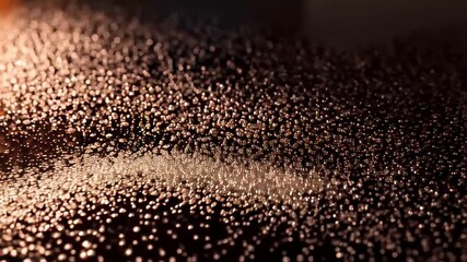 Close-up of thousands of bronze metallic spheres rolling together under soft studio light. Concept of digital particles and transformation - Powered by Adobe