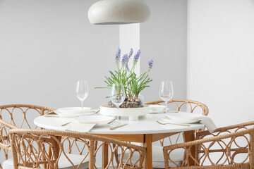 Table setting with beautiful Muscari flowers in dining room