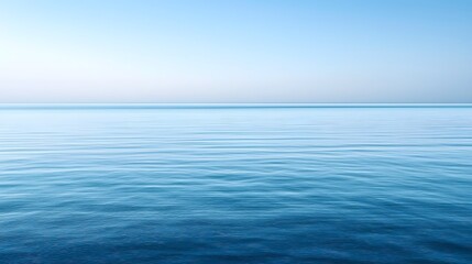 Fototapeta premium Expansive ocean view under a clear blue sky with a minimalist horizon creating a sense of endless tranquility