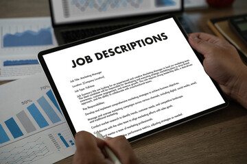 The businesswoman used her laptop to fill out the job application, reviewing the contract and...