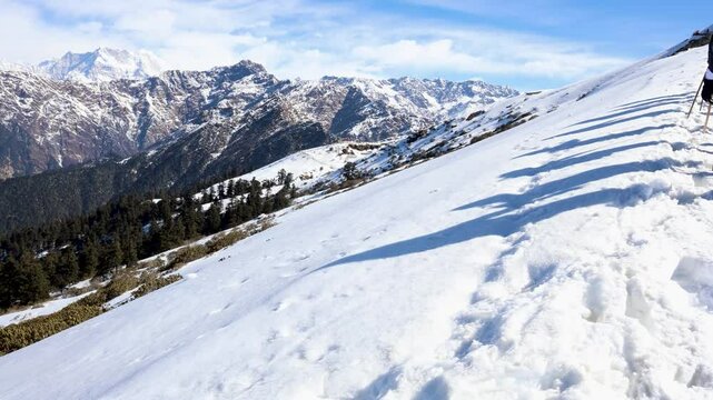 trekking group shadows stretching over fresh snowy landscape