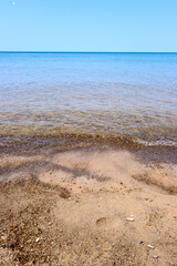 Gentle waves roll onto the sandy beach at Indiana Dunes National Park.