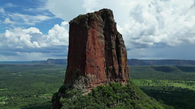 Aerial orbits red sandstone Torre de David pillar near Chochis Bolivia