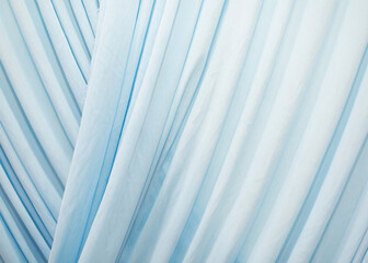 The blue curtains are wavy, soft and flowing.