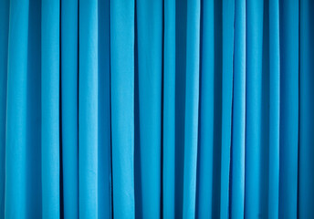 The blue curtains are wavy, soft and flowing.