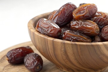 Sweet Delights: Close-Up of Medjool Dates in a Rustic Wooden Bowl