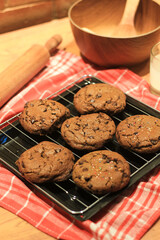 Handmade cookies with chocolate chips on a white plate and fresh milk in a glass. Selective focus