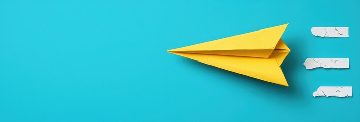 Vibrant Yellow Paper Airplane in Flight Against a Bright Turquoise Background