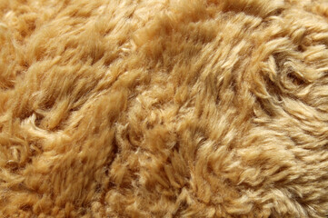 Fluffy brown faux fur plush fabric material textured background