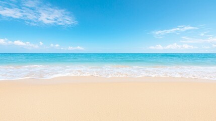 Beautiful serene sandy beach with clear blue sky and white clouds, a relaxing vacation destination