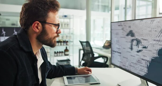 Engineer, computer and man on screen with map for wind turbine location or renewable research. Monitor, worker and global planning in office for sustainable project, data and clean energy analyst