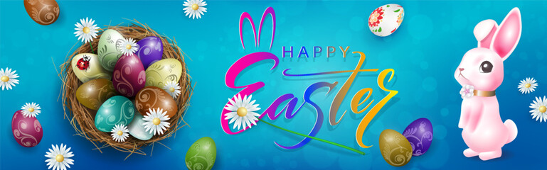 Composition with Easter eggs in a straw nest and a cute rabbit.