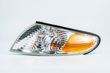 Automotive Turn Signal Light with Clear and Amber Lens Isolated on off-White ground. Industrial car...