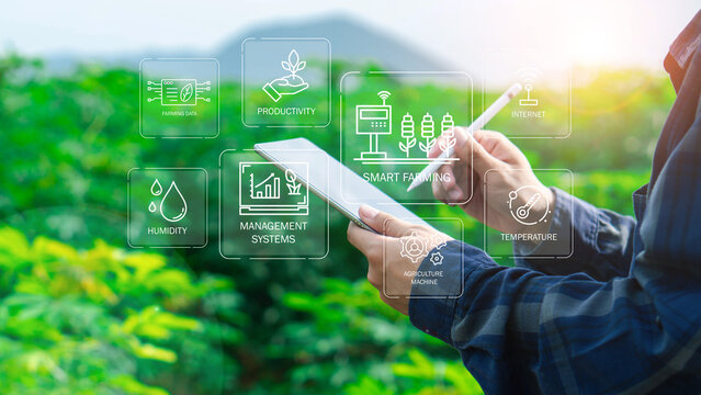 Farmers use agricultural technology in data analysis tablets and image icons. New technologies in agricultural business concepts. Men use tablets to research and develop plant varieties, agricultural