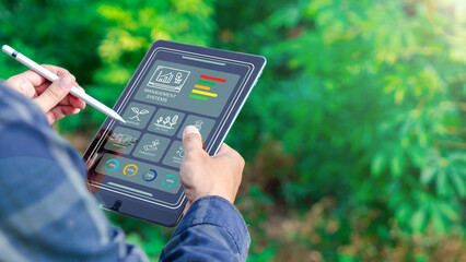 Farmers use agricultural technology in data analysis tablets and image icons. New technologies in agricultural business concepts. Men use tablets to research and develop plant varieties, agricultural