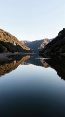 Douro Reflections in Portugal Porto, showcasing calm waters mirroring mountains under blue sky. Concept of Douro Reflections in Portugal Porto, tranquil landscape atmosphere.