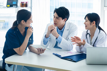 Multidisciplinary Medical Team Planning Treatment in Office
Three healthcare workers in a medical...