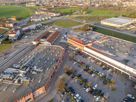 Iper Rossetto shopping mall parking lot with cars during sunset, aerial view