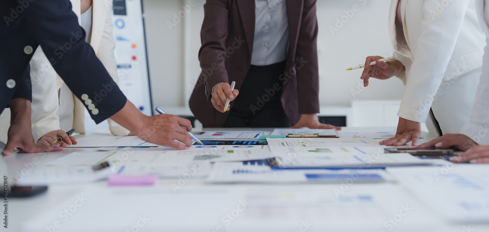 Poster business team analyzing financial charts and graphs, pointing at statistics and discussing data duri
