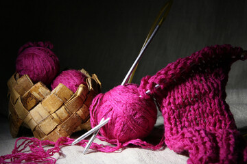 Knitting with pink threads.