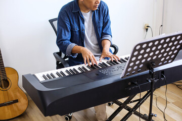 Unrecognizable Musician Man Playing On Piano Keyboard At Home