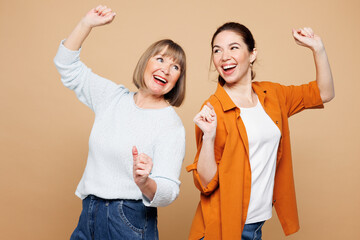 Elder fun parent mom 50s year old with young adult daughter two women together wears casual clothes...