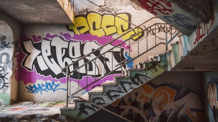 Fototapeta premium A stunning 3D rendering of a crumbling, graffiti-covered interior staircase with metal railings 